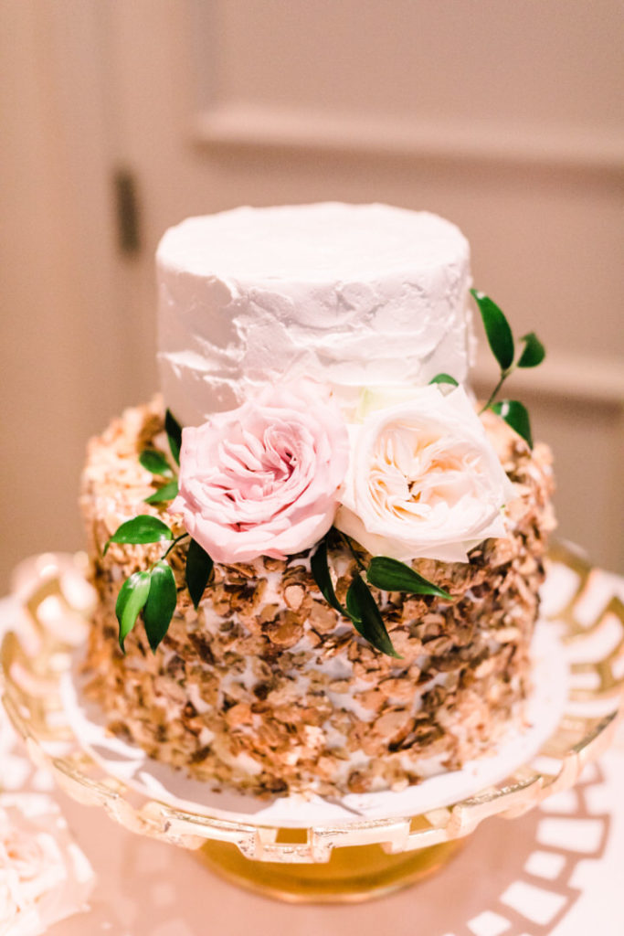 Baked almond torte cake from Bethel Bakery decorated with roses and greenery
