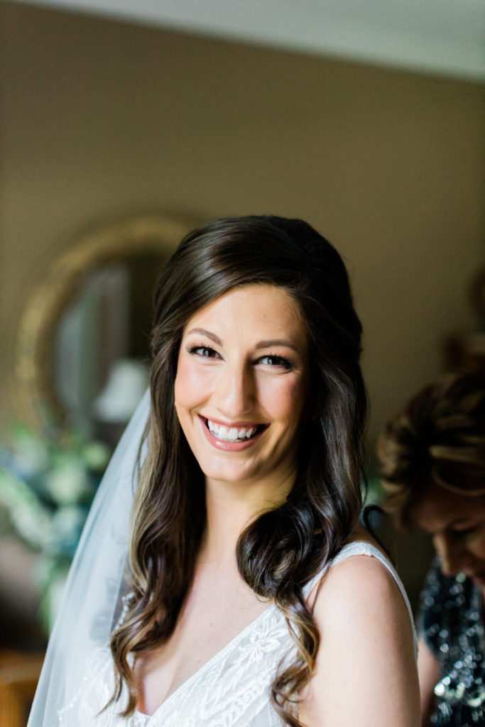 Bride smiles at the camera before Summer Edgewood Club wedding