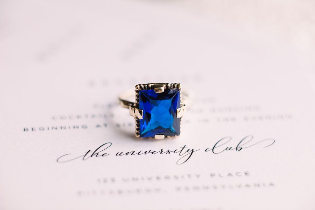 Macro photo of sapphire blue ring on wedding stationery