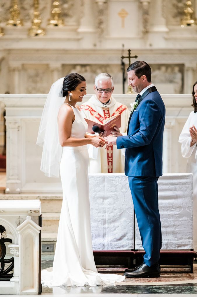 Bride and groom exchange wedding rings at St. Paul Cathedral