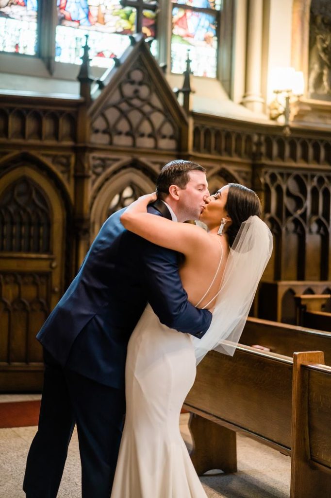 Bride and groom exchange a kiss inside St. Paul's Cathedral in Oakland