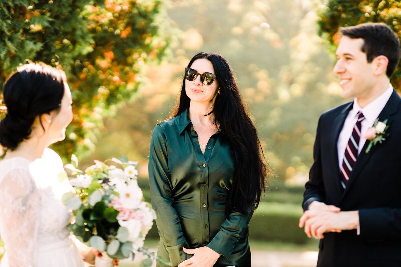 Bride and groom smile as they say their vows in a fall Mellon Park elopement