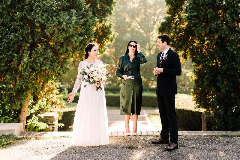 Bride and groom smile as they say their vows in a fall Mellon Park elopement