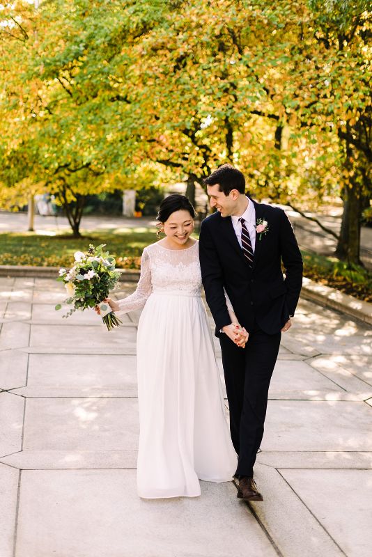Bride and groom pose for photos after fall Mellon Park elopement