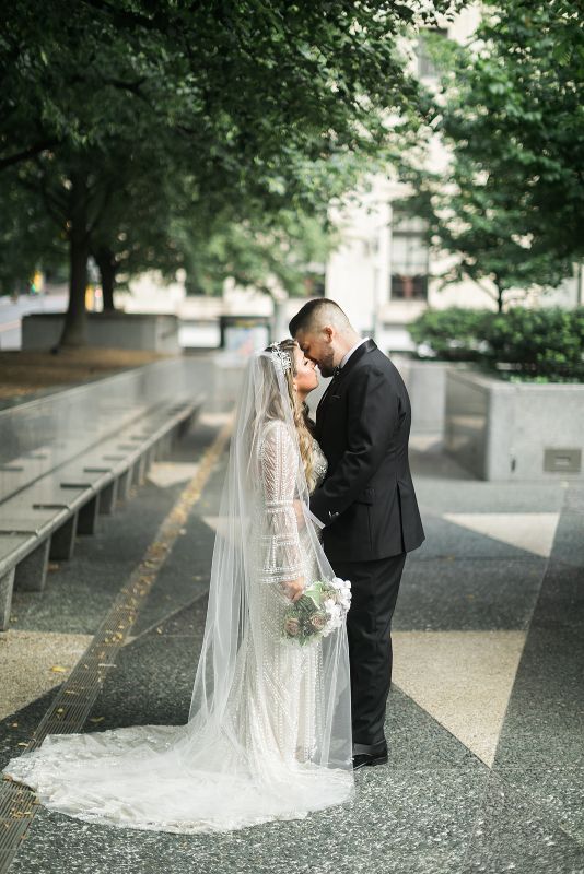 Bride and Groom share intimate moment in Mellon Square