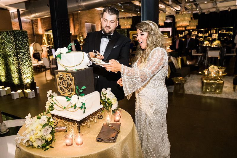 Bride and groom cut their Black, white and gold wedding cake for Glam Pittsburgh Opera Wedding Reception