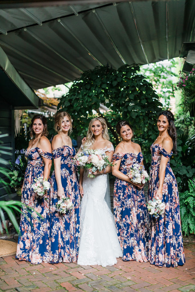 Bride and bridesmaids pose in the courtyard of the Morning Glory Inn