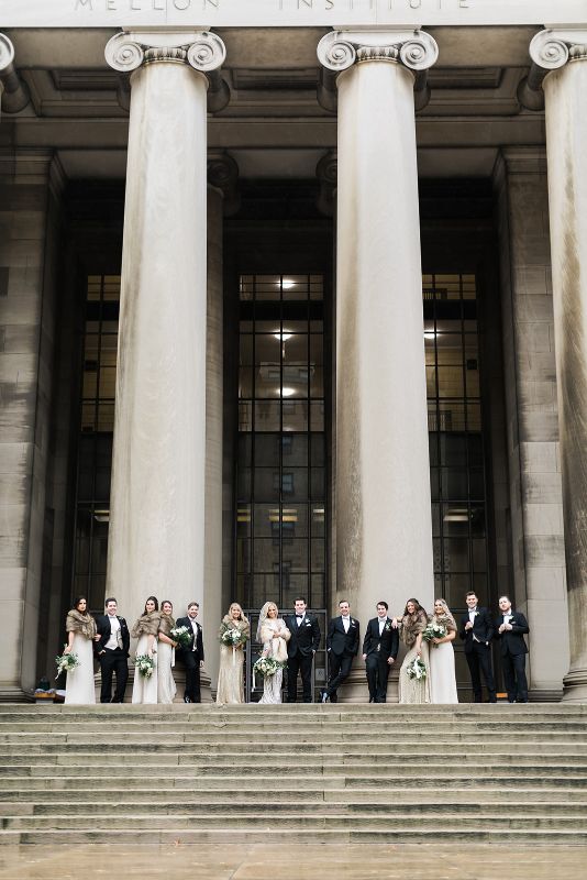 Bridal party poses at the Carnegie Mellon College of Engineering pillars