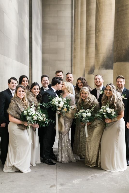 Bridal party poses at the Carnegie Mellon College of Engineering pillars
