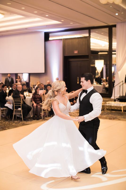 Bride and groom smile and perform their first dance at their Westin Convention Center Wedding