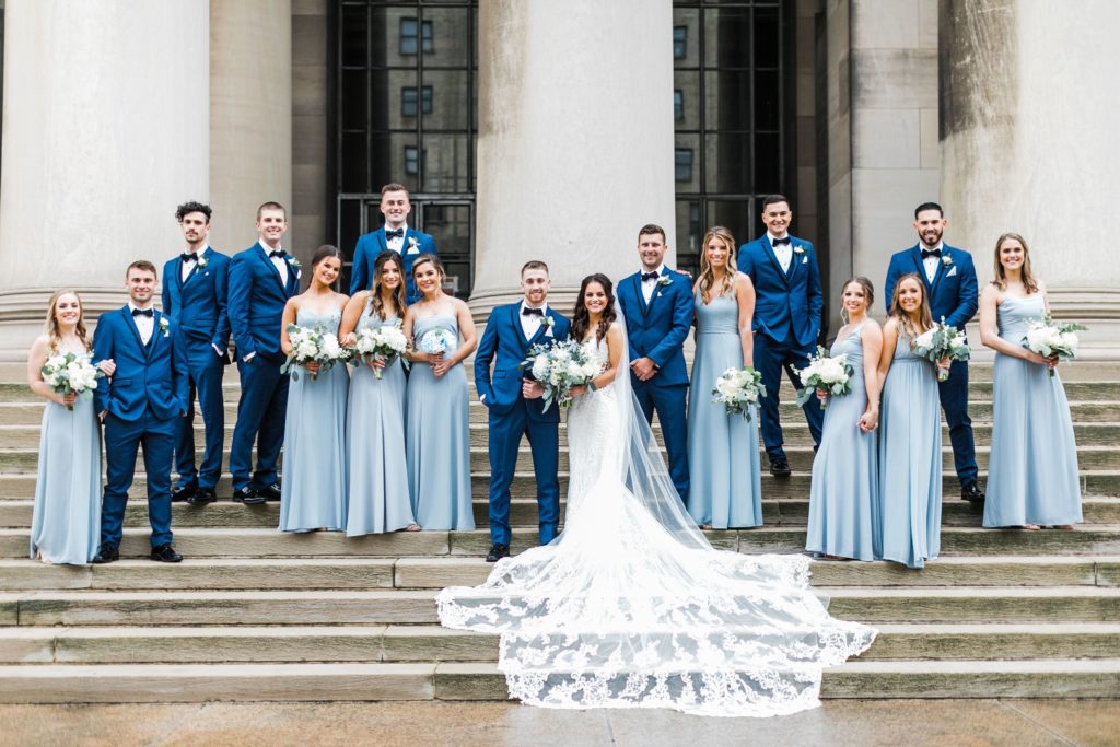 Bride and groom with bridal party posed on the steps of the Carnegie Mellon College of Engineering building