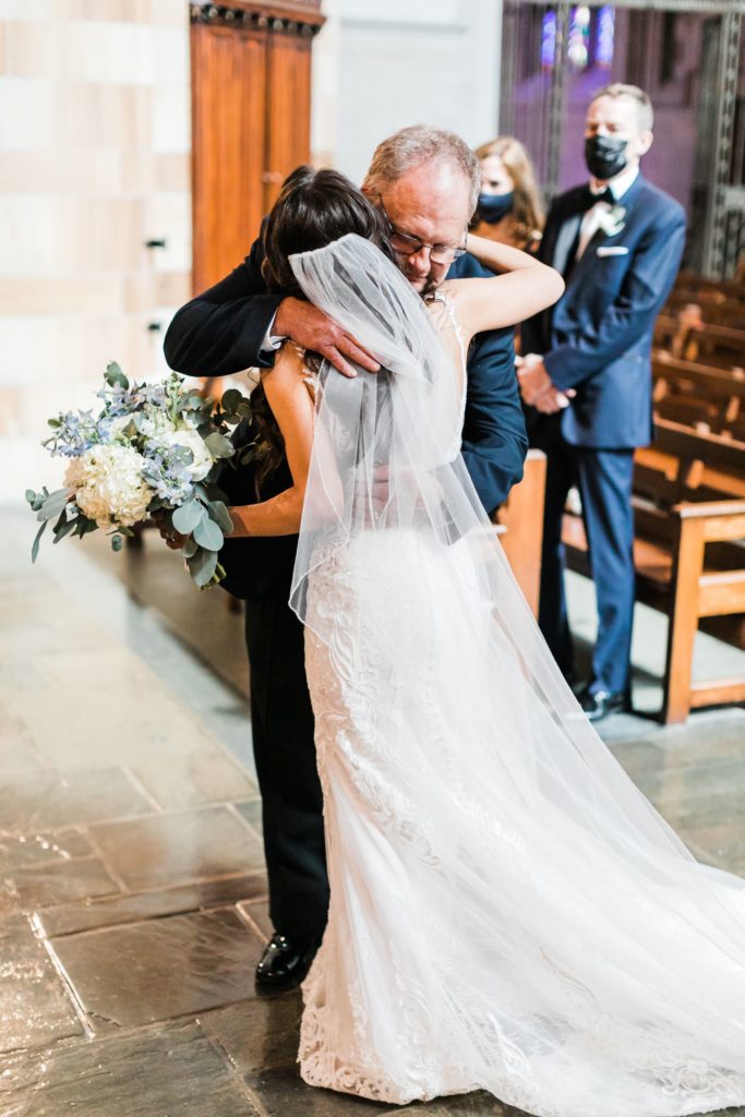 Bride and her father hug at the altar of Sacred Heart Church in Shadyside 