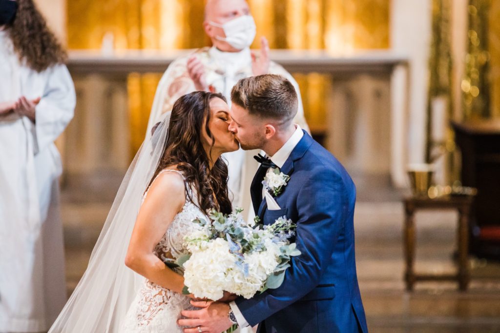 Bride and groom share their first kiss at Sacred Heart in Pittsburgh