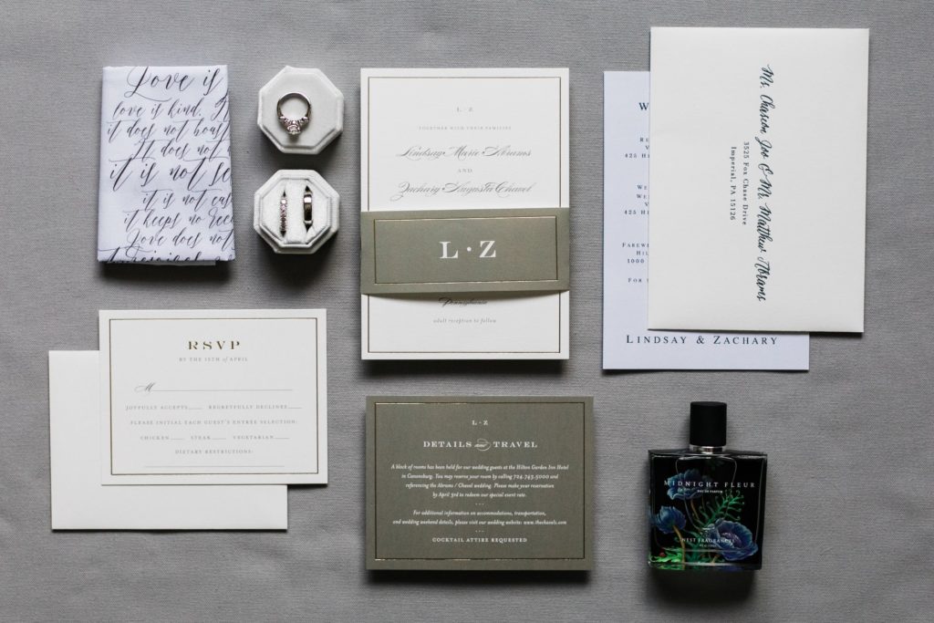 Detail photo of invitations, rings, and other sentimental things related to a wedding