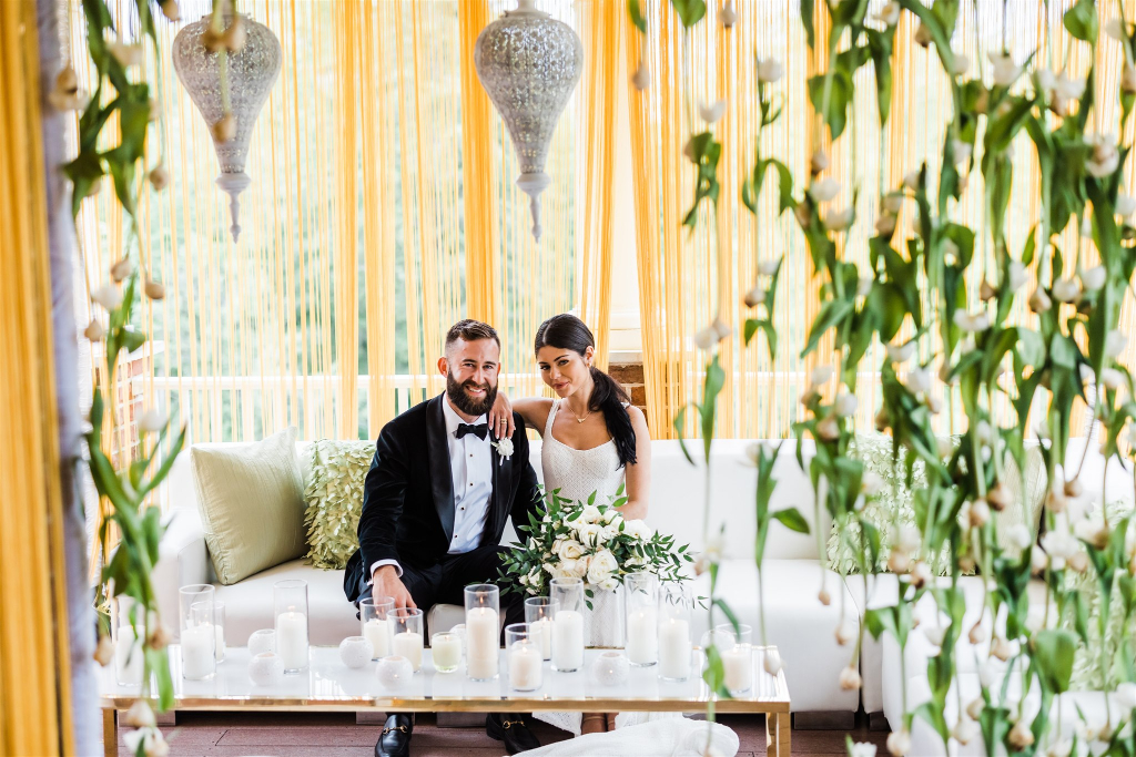 Bride and groom post in lounge area of Luxe Intimate Home Wedding reception