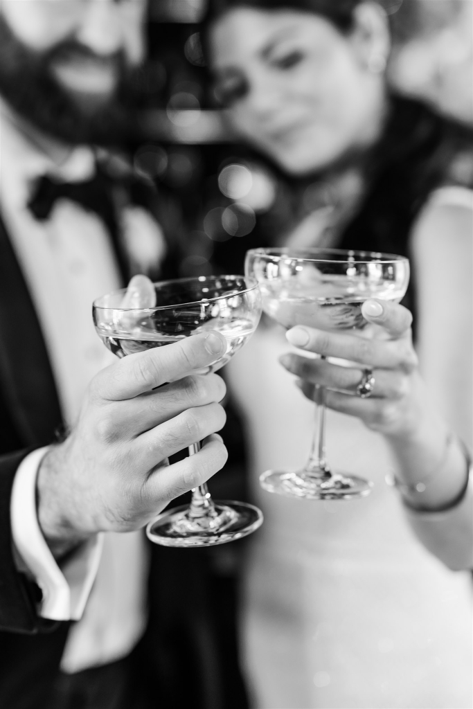 Close up photo of Bride and groom share a private champagne toast