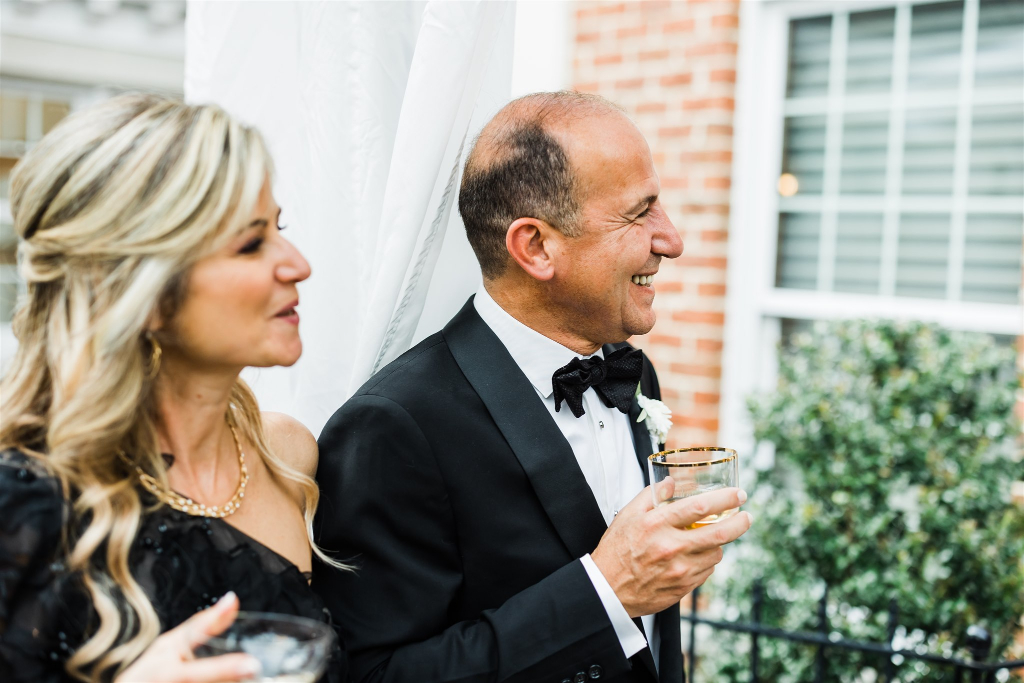Parents of the bride laugh and enjoy Luxe Intimate Home Wedding reception