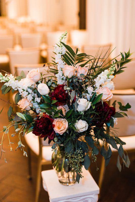 Burgundy, peach and white floral arrangement at Hotel Monaco wedding