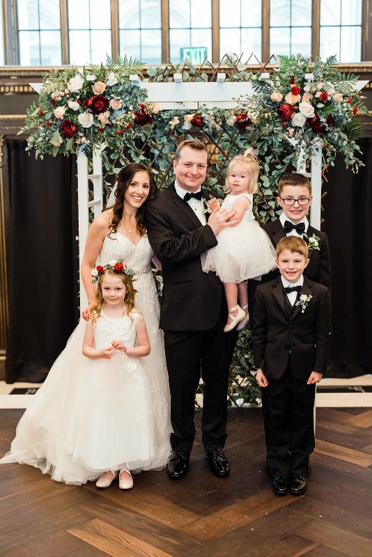 Bride and groom pose with their children