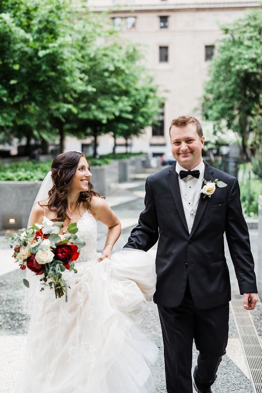 Bride and groom walk together through Mellon Square in Pittsburgh