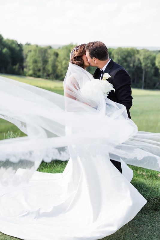 Bride and groom kiss outside at Nemacolin Resort 