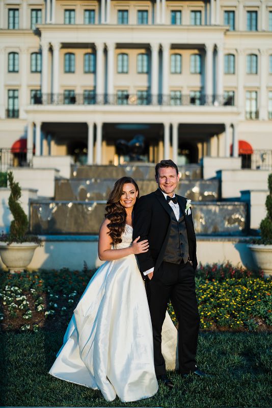 Bride and groom smile at the camera at Nemacolin Resort 