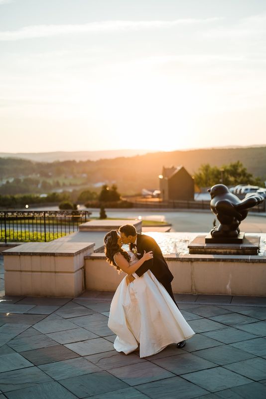Sunset kiss between bride and groom at Nemacolin Resort