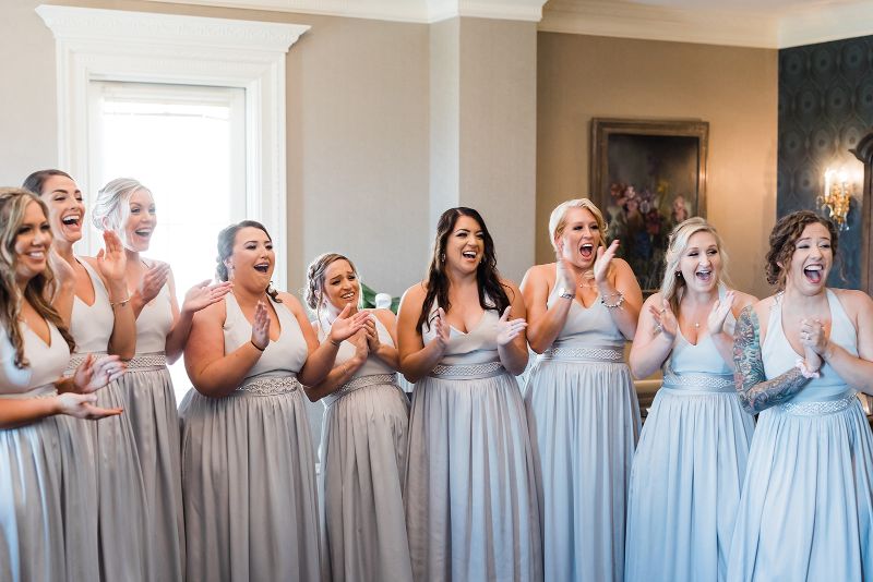Bridesmaids react to seeing bride for the first time in her wedding gown