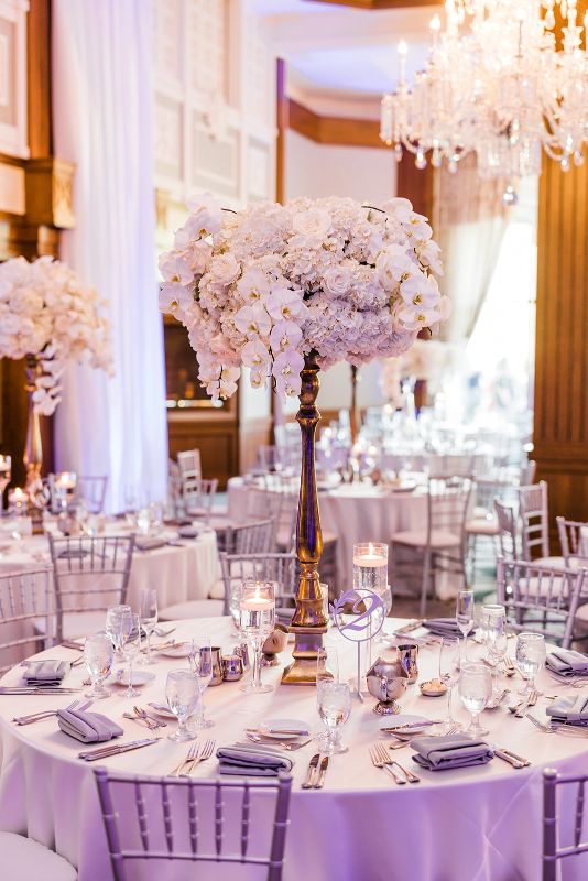 Tall all white orchid and hydrangea centerpieces at monochromatic Nemacolin Resort wedding reception
