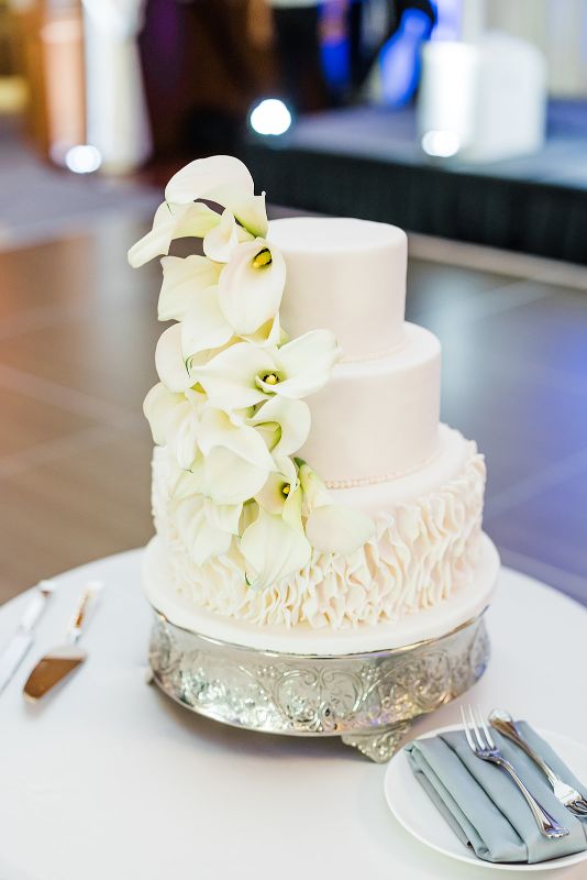 Monochromatic white ruffled wedding cake