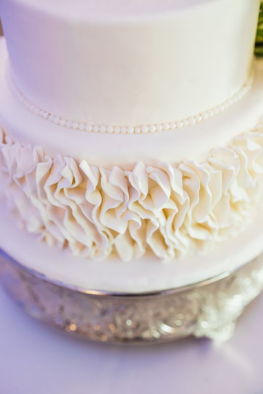 Monochromatic white ruffled wedding cake