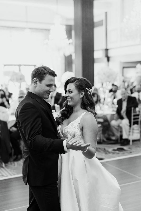 Bride and groom share first dance at at monochromatic Nemacolin Resort wedding reception