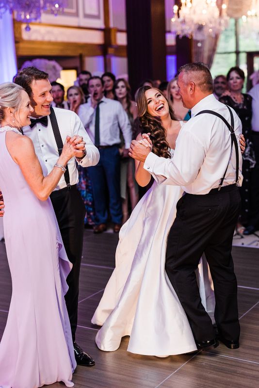 Mother son and father daughter dance at monochromatic Nemacolin Resort wedding reception