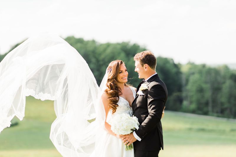 Bride and groom smile at the camera at Nemacolin Resort 