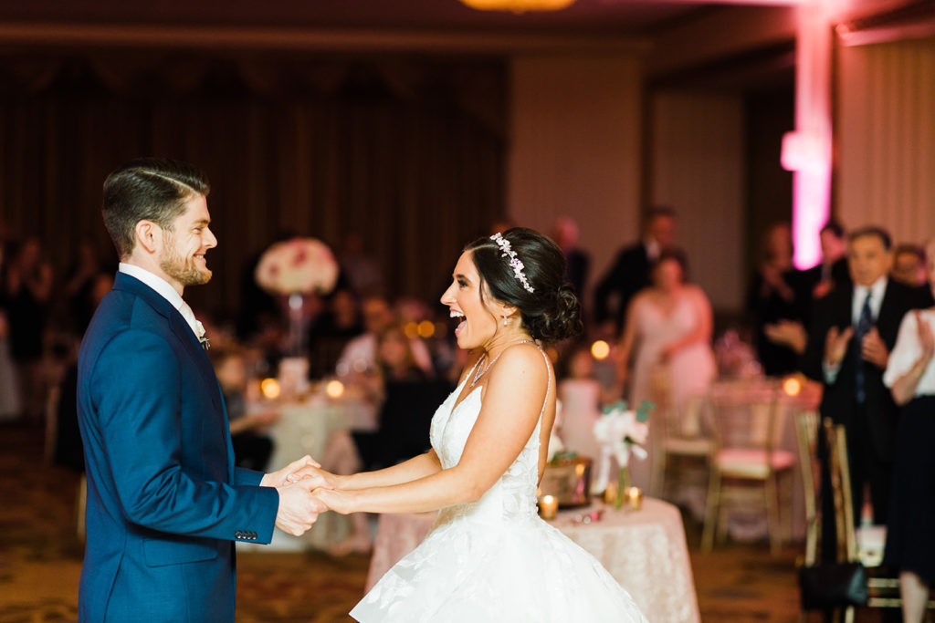 Bride and groom dance and smile on the dance floor of their Omni William Penn wedding 