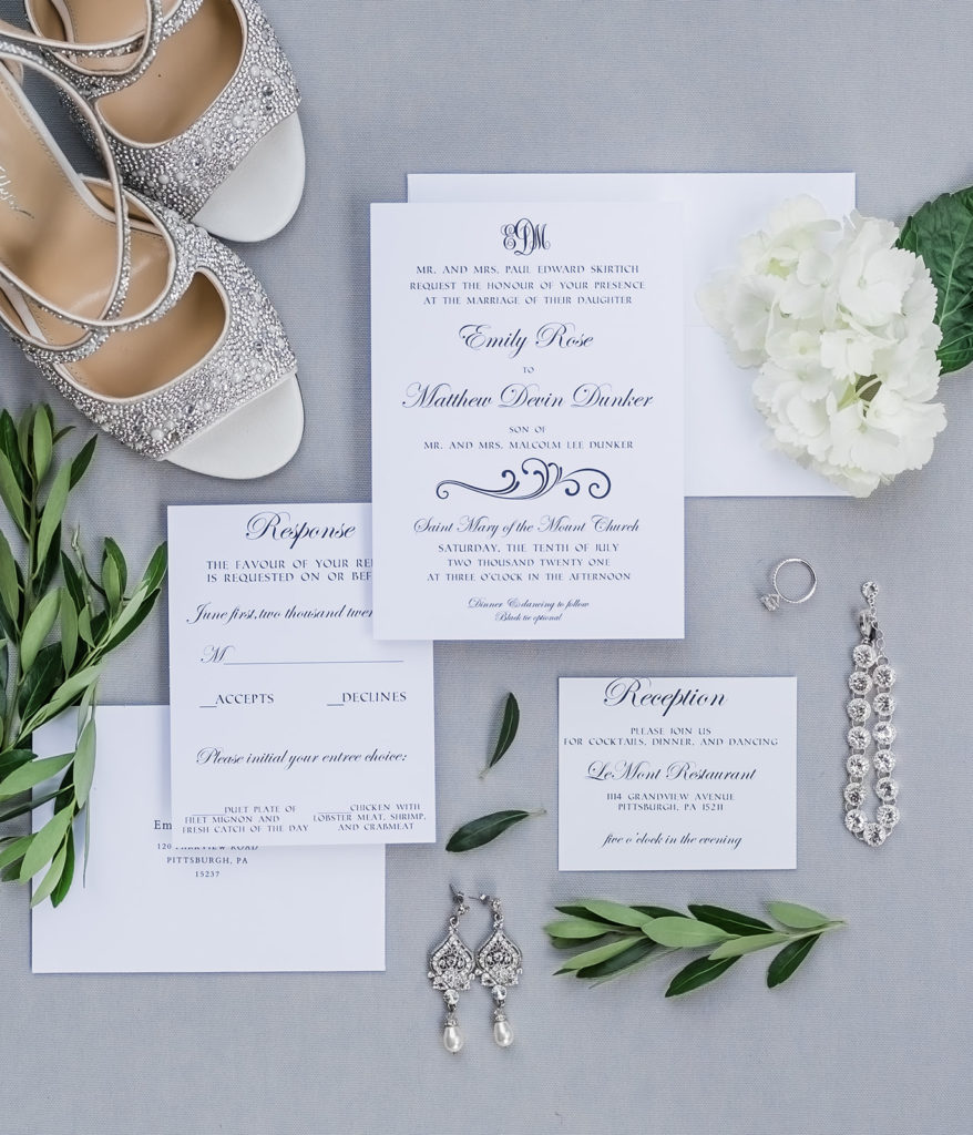 Ivory, white and green wedding flat lay with silver and green details. 