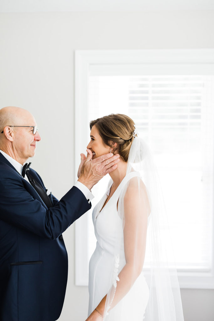 Bride and father share an intimate moment before the wedding ceremony