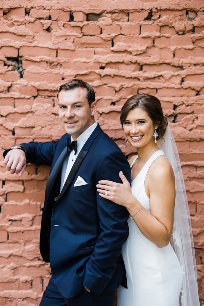 Bride and groom pose in downtown Pittsburgh