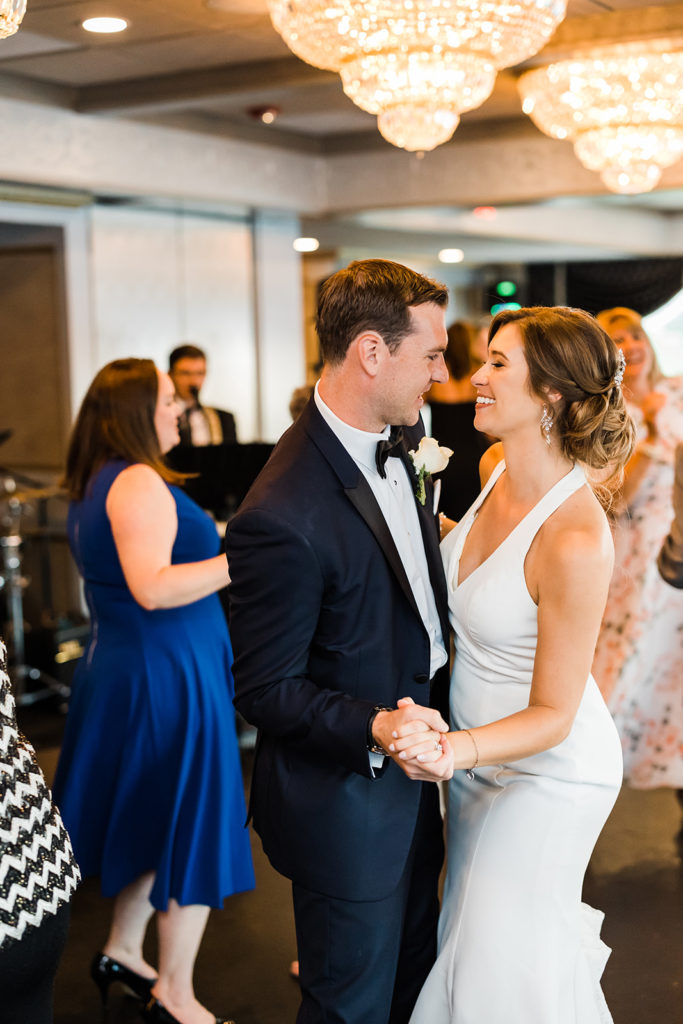 Bride and groom dance together at their Pittsburgh city view wedding reception at the LeMont