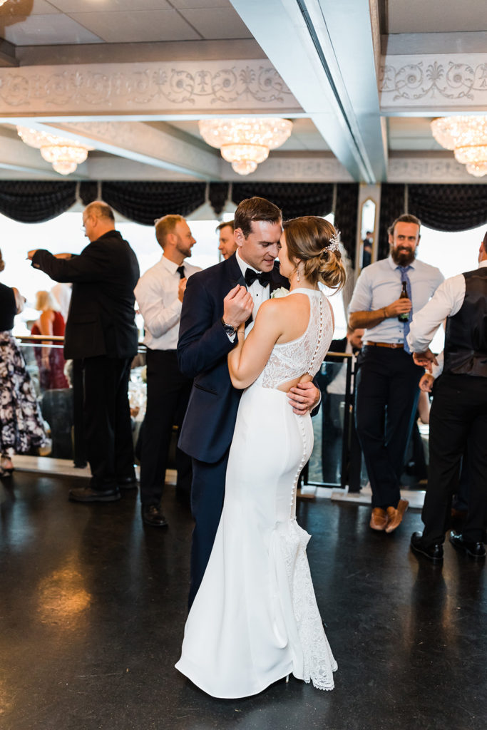 Bride and groom dance together at their Pittsburgh city view wedding reception at the LeMont