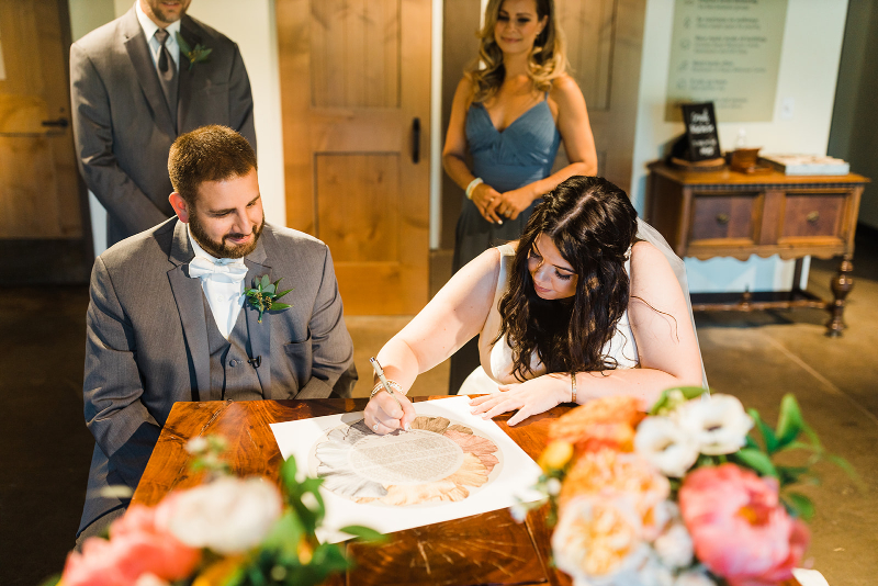 Bride and groom sign their wedding ketubah at the Pittsburgh Botanic Garden