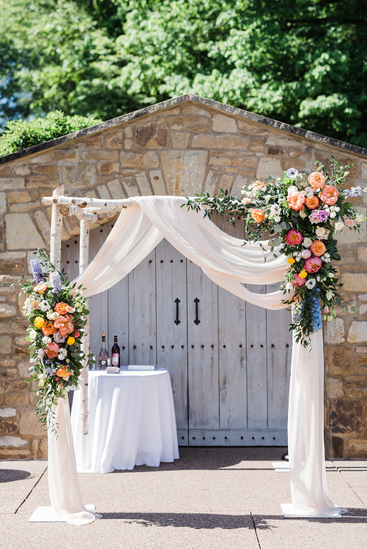 Brightly colored floral arch by the Farmer's Daughter's Flowers