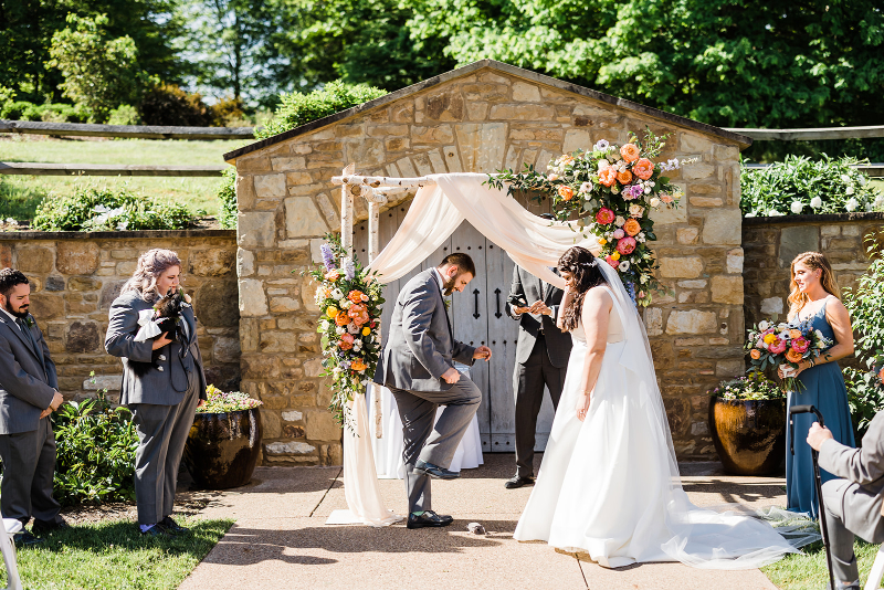The groom crushes the glass at the end of a vibrant Pittsburgh Botanic Garden wedding