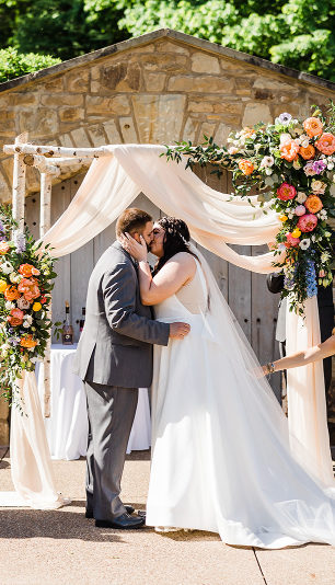 The bride and groom share their first kiss