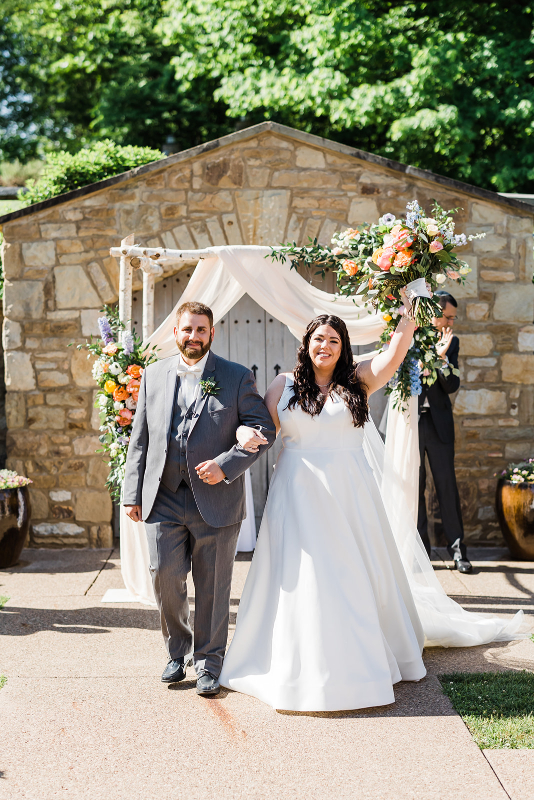 The bride and groom celebrate with their first steps together as husband and wife