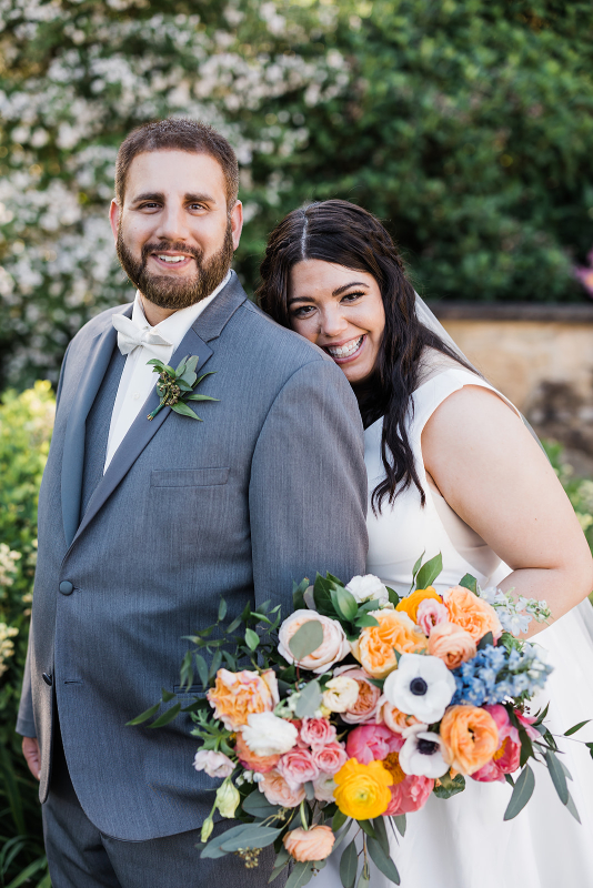 Bride and groom pose together at their vibrant Pittsburgh Botanic Garden wedding