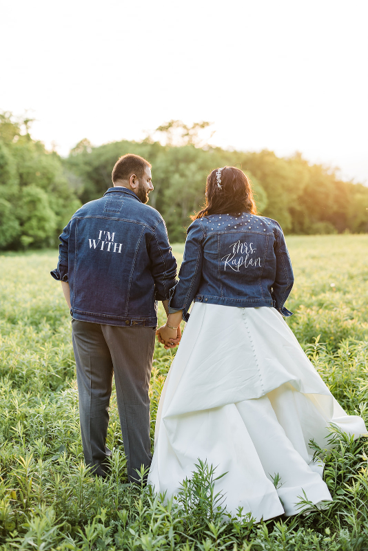 Bride and groom wearing custom wedding jean jackets