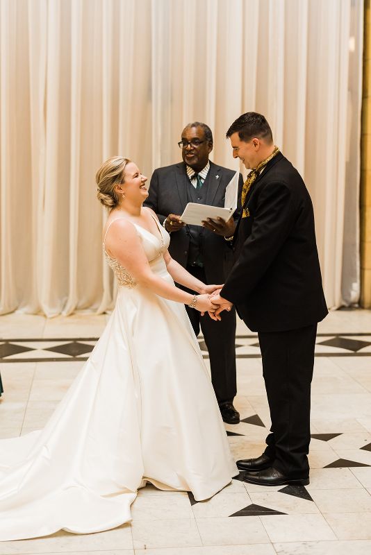Bride and groom laugh during their downtown Pittsburgh vow renewal ceremony