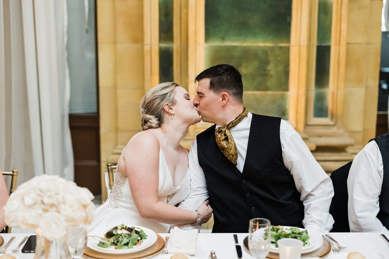 bride and groom share a kiss during their downtown Pittsburgh vow renewal reception