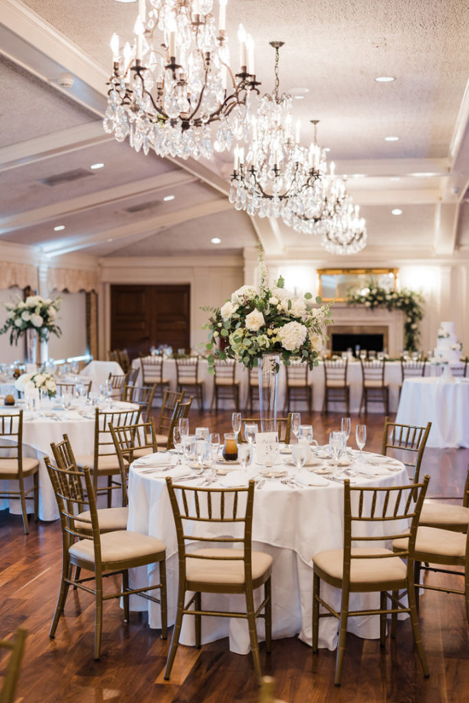 Ballroom featuring White, ivory and green high centerpieces at Oakmont Country Club wedding